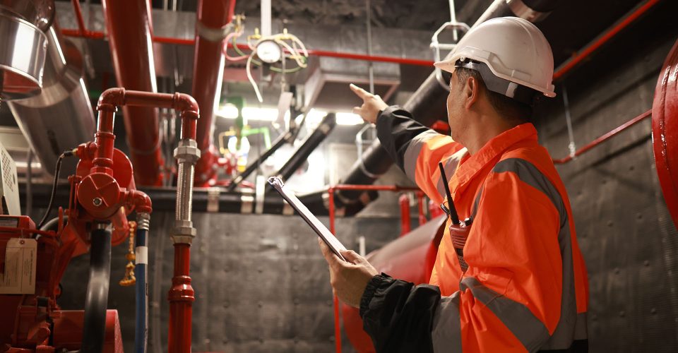 The engineer inspects the safety equipment on the fire extinguishing system.